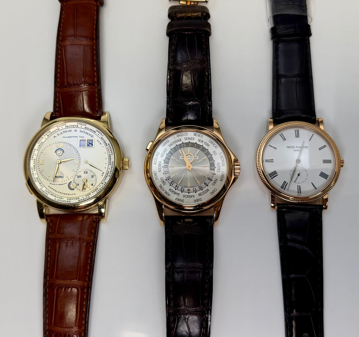 Explore luxury wristwatches: three round watches with leather straps and contrasting dial designs.